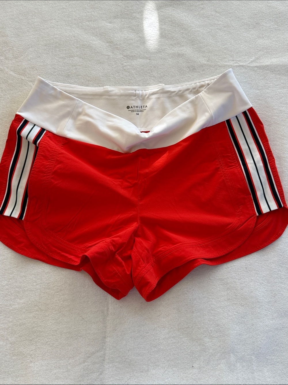 Athleta deep orange Athletic Shorts with White Waistband and Side Stripes
